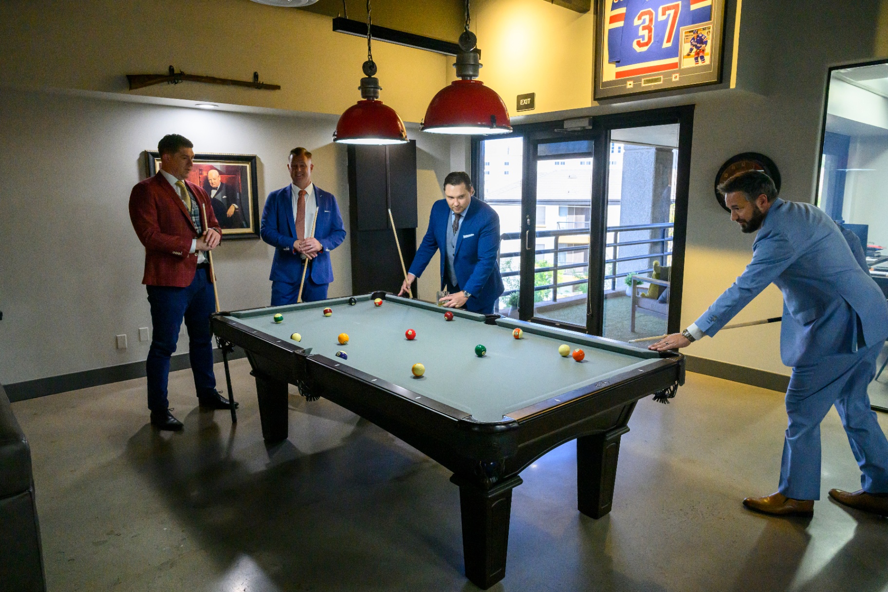 PHG team around the pool table